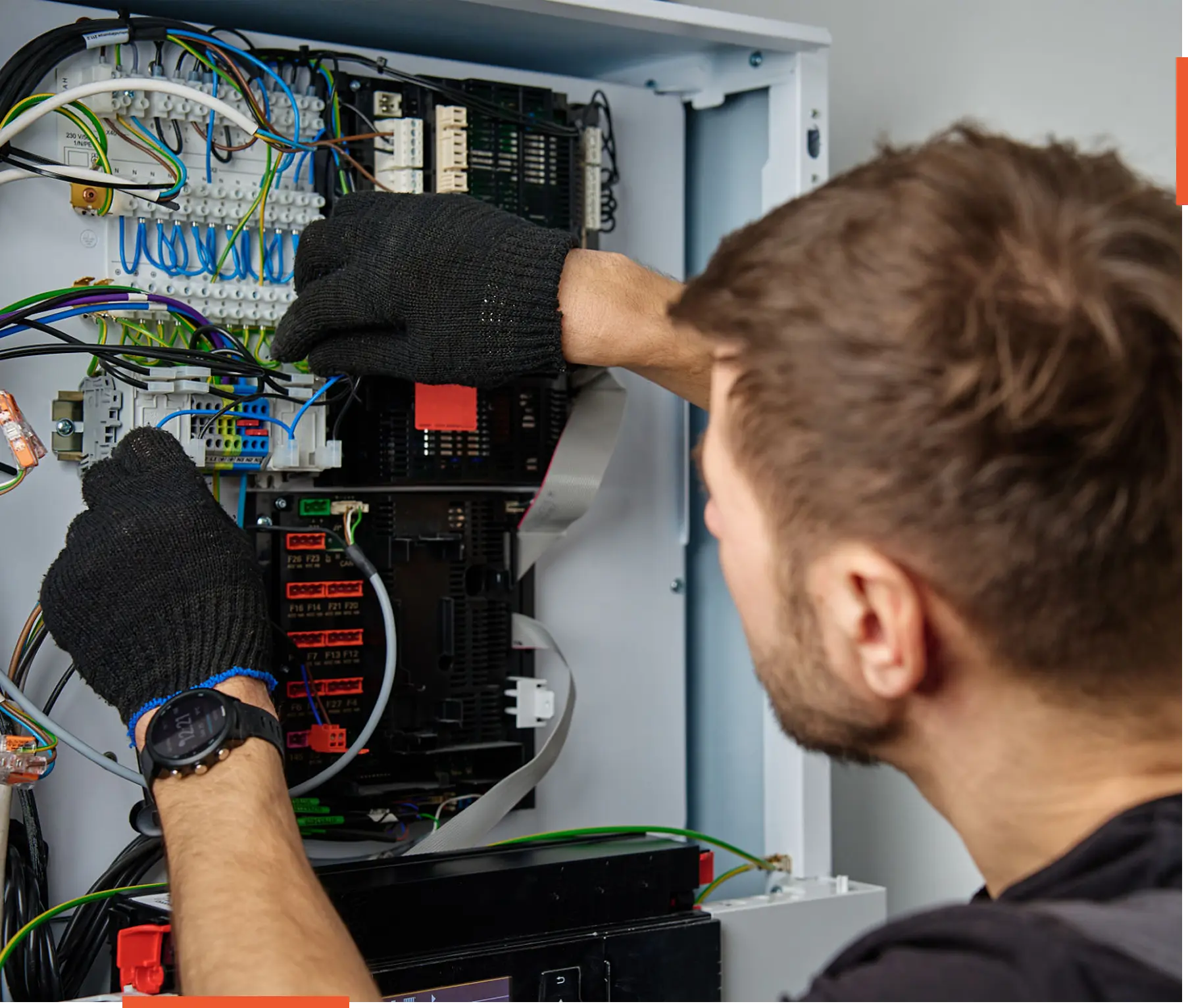 Technician adjusting electrical panel components